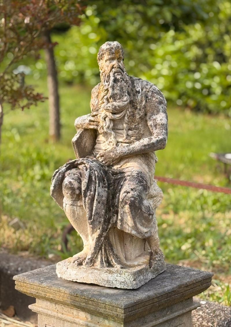 Moses in the garden, with the tablets of the law.